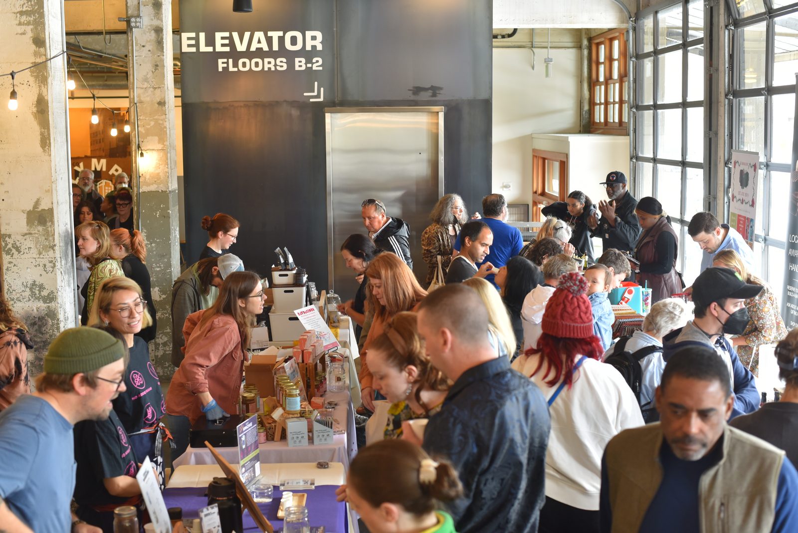 A busy festival floor filled with guests and makers